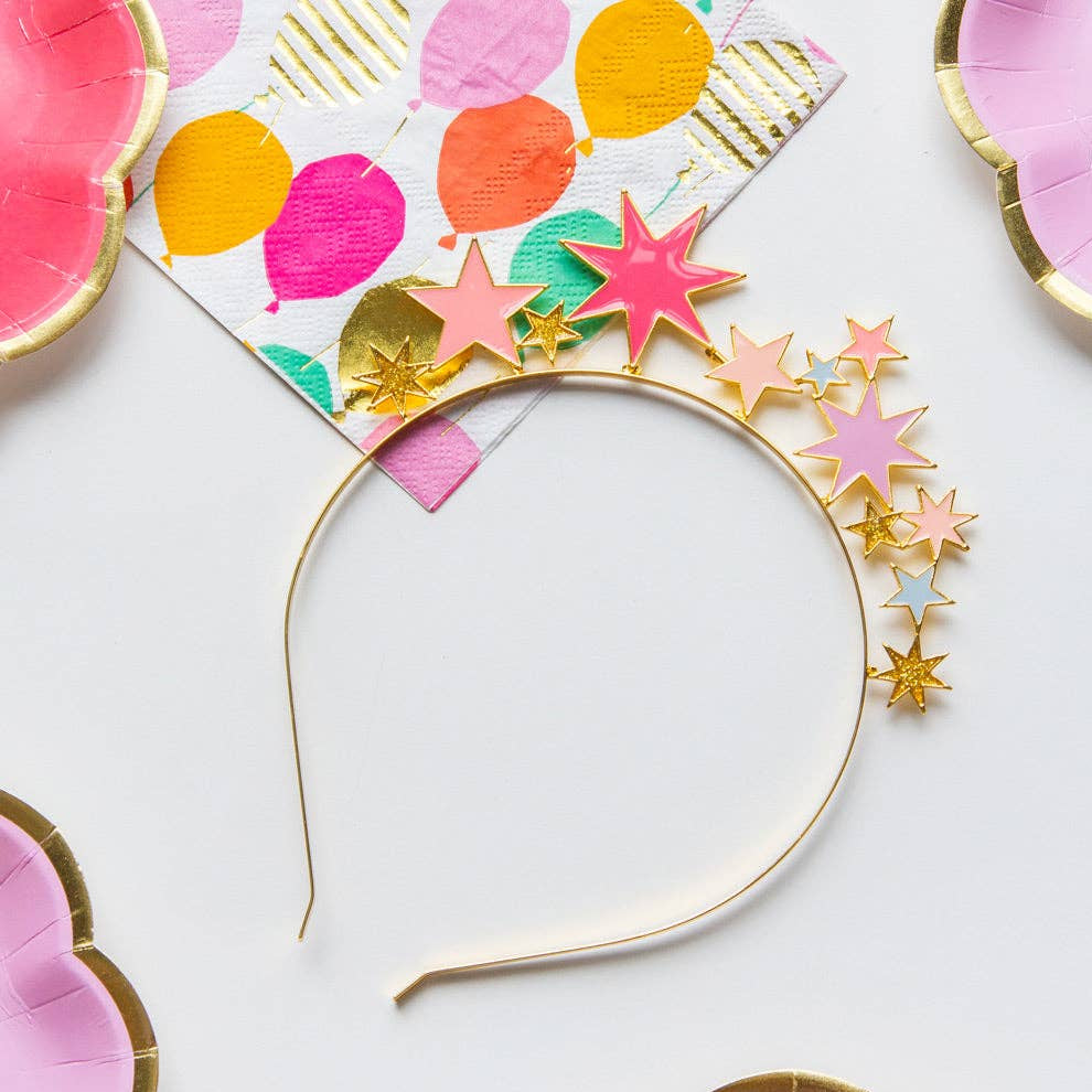 Decorative headband with colorful star and circle patterns on a white background