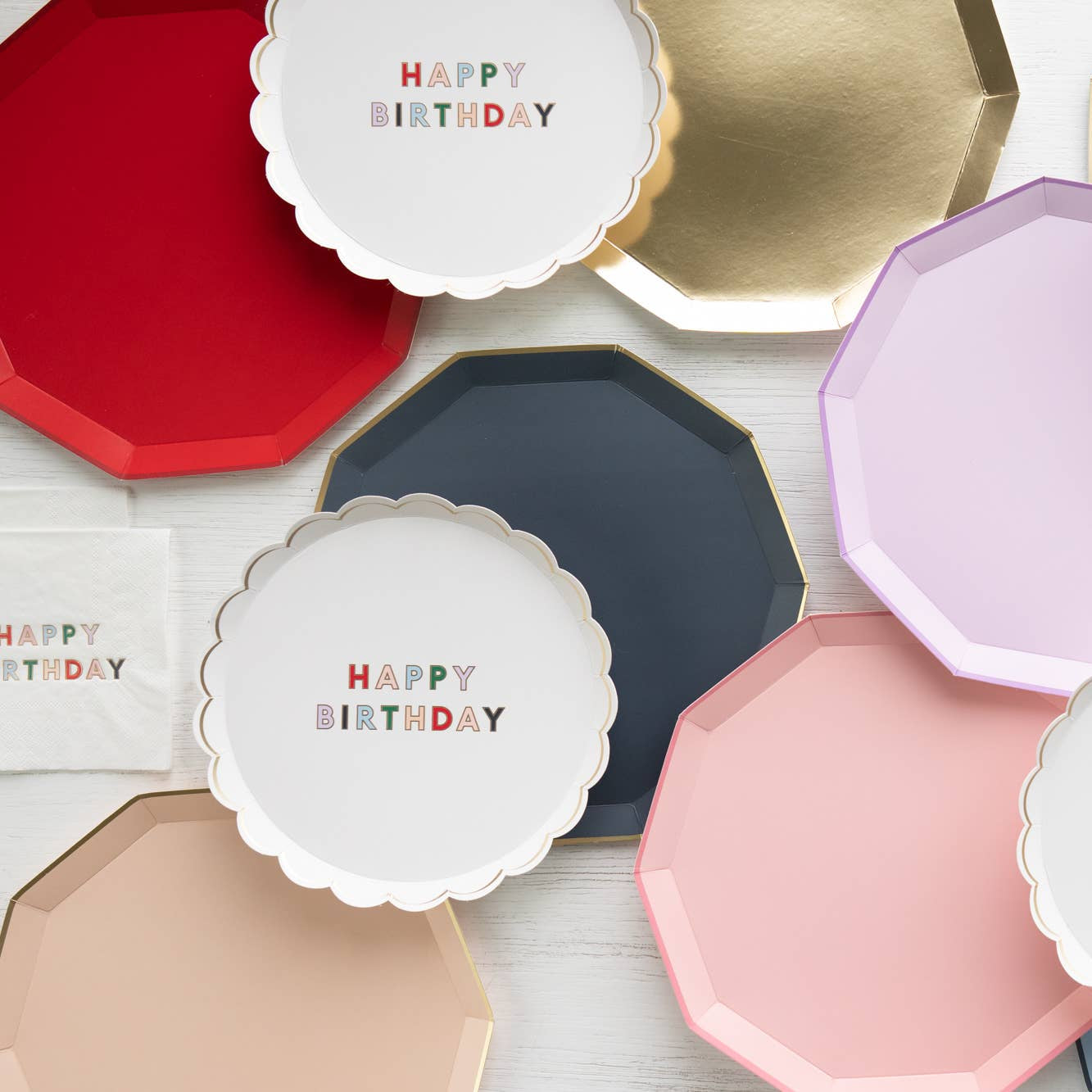Assortment of colorful plates with 'Happy Birthday' text