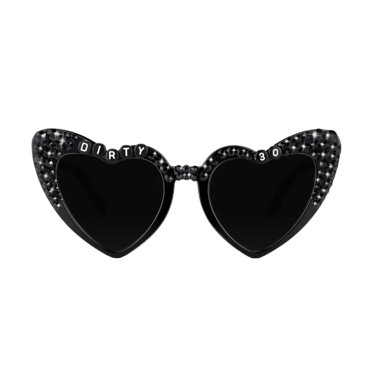 Black heart-shaped sunglasses with rhinestone embellishments on the outer edges, featuring the word 'DIRTY' on one lens and '30' on the other, set against a plain white background.