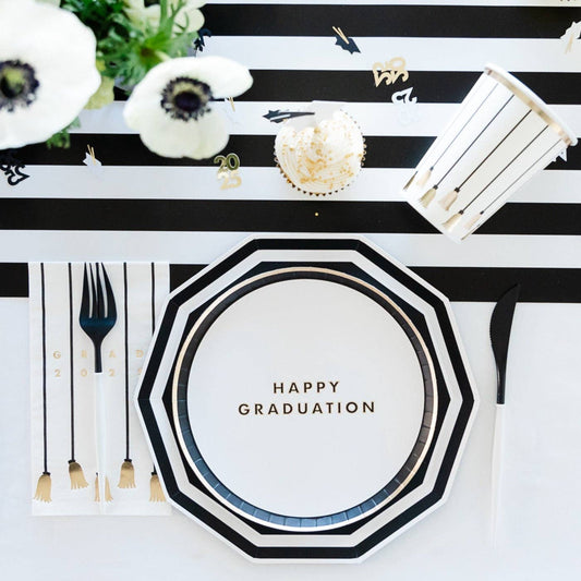 Graduation-themed table setting with 'Happy Graduation' plate, black and white