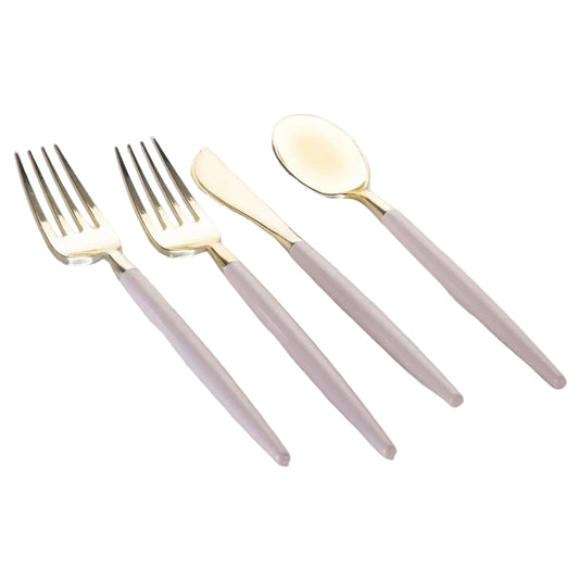 Set of gold cutlery with pink handles on a white background,