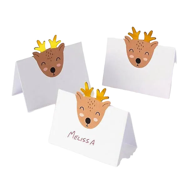 Three white A-frame place cards on a white background, each decorated with a cute cartoon reindeer face witg gold antlers