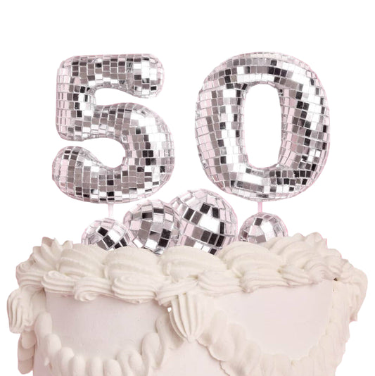 Silver disco ball number '50' on a cake with a white background