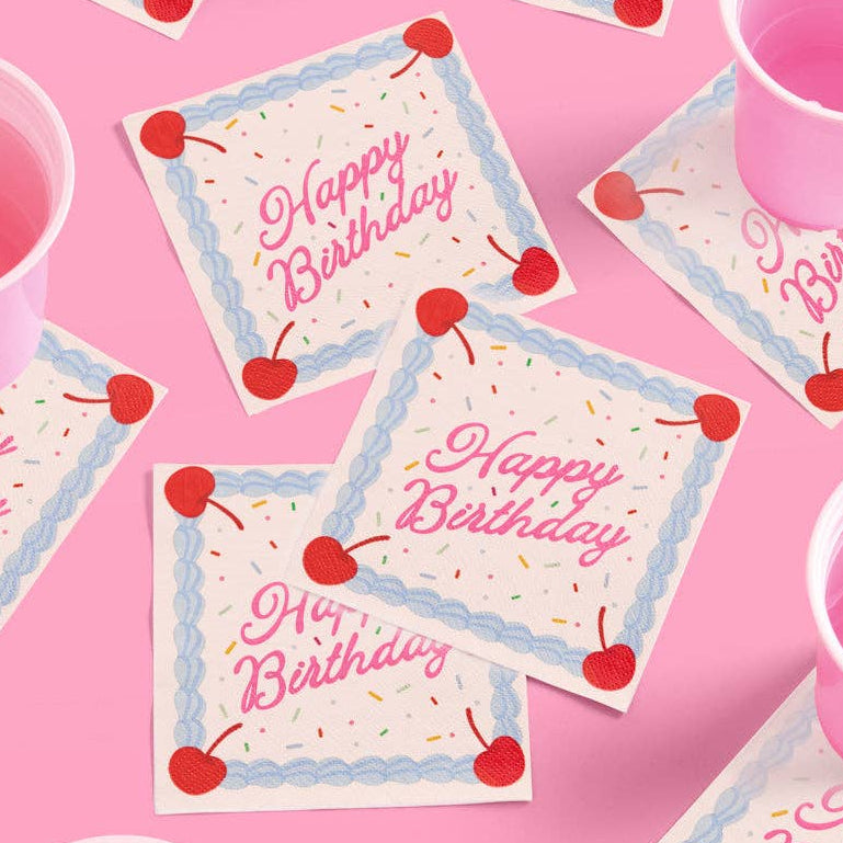Happy Birthday napkins with cherries on a pink background