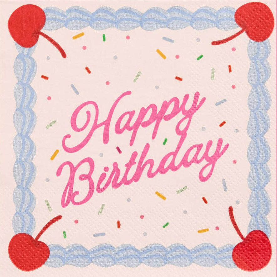 Happy Birthday cocktail napkin with cake design, cherries, and sprinkles on a pink background