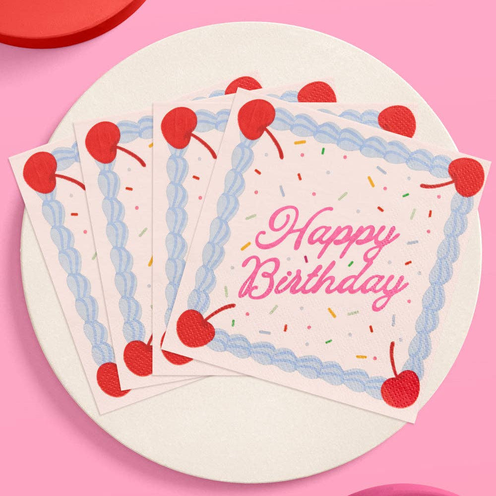 Set of birthday napkins with cherries and 'Happy Birthday' text on a pink background