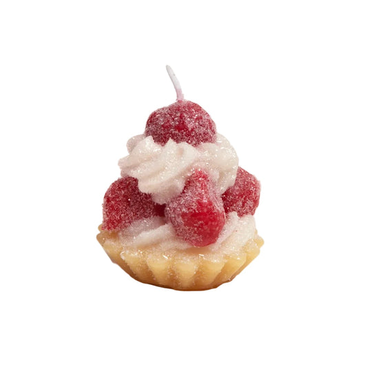 Candle shaped like a dessert with raspberries and cream on a white background