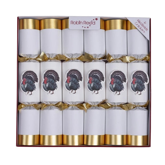 A boxed set of 6 white Christmas crackers with gold bands, tied with gold ribbons, and printed with a turkey illustration. 
