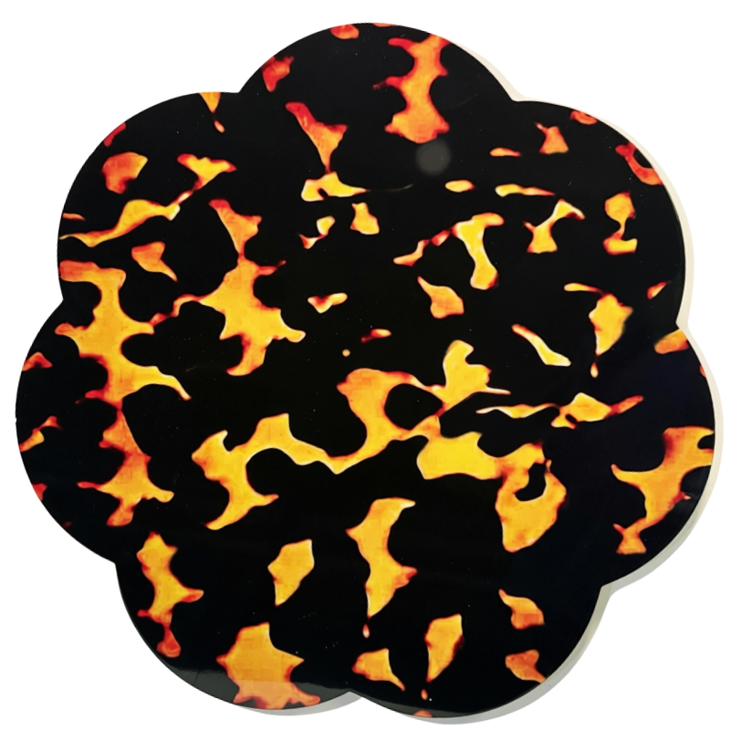 A scalloped circular coaster or mat featuring a glossy black background with a vibrant orange and yellow flame-like pattern, shown on a plain white background.