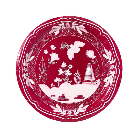 Decorative red paper plate with white floral and leaf pattern on a white background