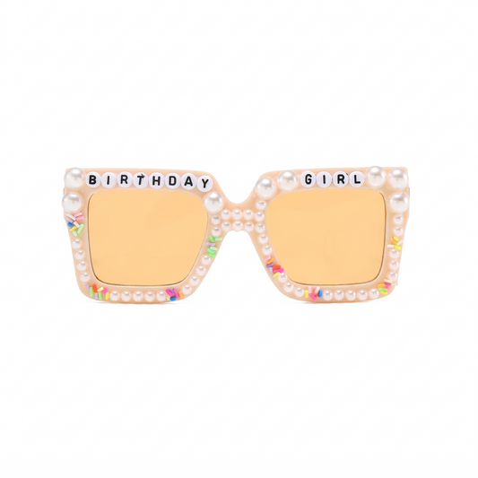 Sunglasses with 'Birthday Girl' text and pearl embellishments on a white background