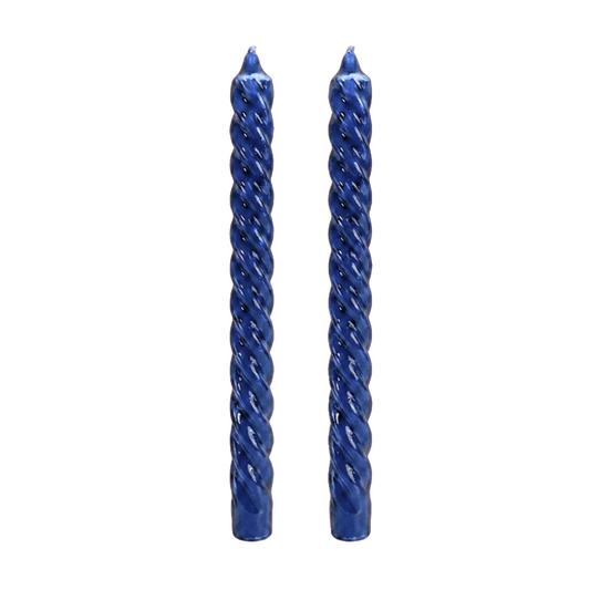 two twisted taper candles in a glossy cobalt blue finish, standing upright side-by-side on a plain white background.