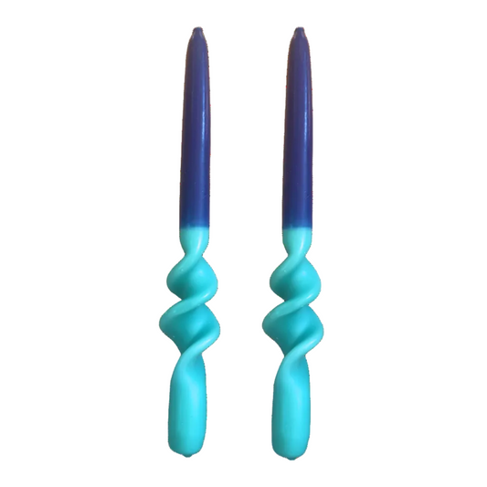 Two spiral-shaped candles with a dark blue to light blue gradient top and a bright turquoise lower body, shown on a plain white background.