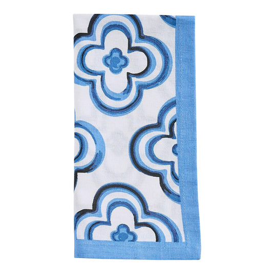 Decorative cloth napkin with blue quatrefoil pattern on a white background