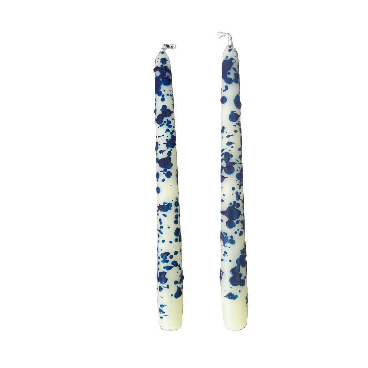 Two long taper candles with a blue and white splatter pattern, standing upright against a plain white background.