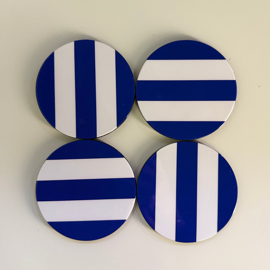Set of four blue and white striped coasters on a white background 