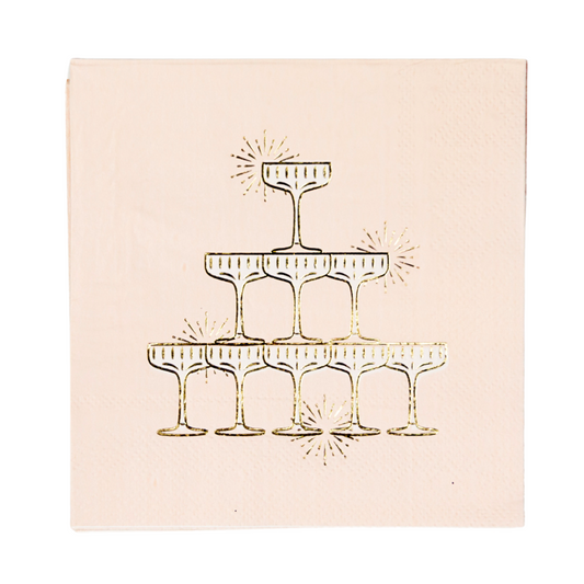 Blush napkin with gold foil design of champagne glasses on a white background