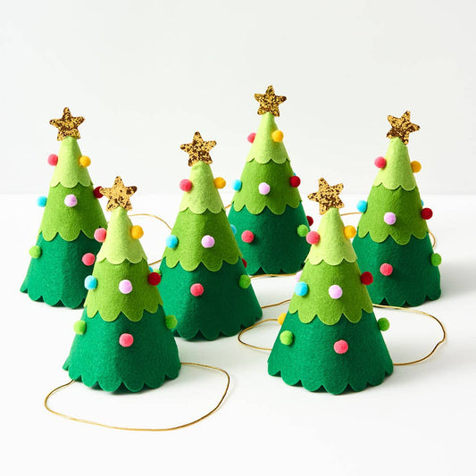 Set of six green felt Christmas tree party hats decorated with colorful pom-poms and gold glitter star toppers, arranged on a white background.