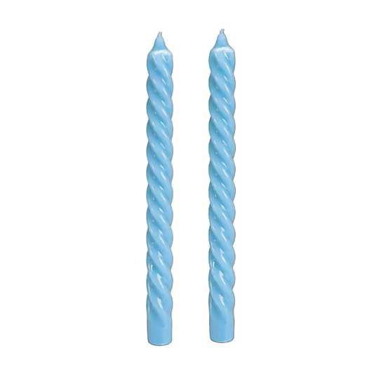 Two light blue spiral twist candles standing upright against a plain white background.
