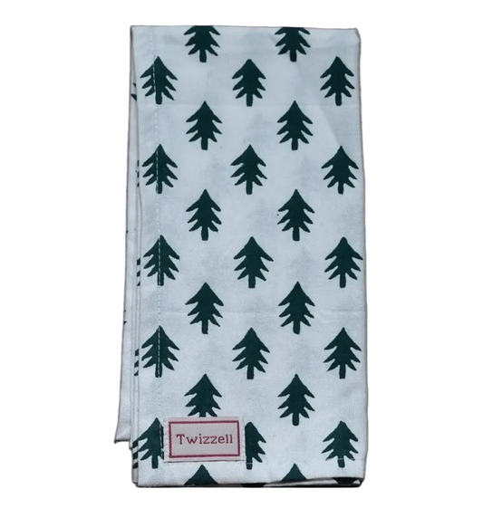 Folded napkin with green tree pattern on a white background, featuring the brand 'Twizzell'.