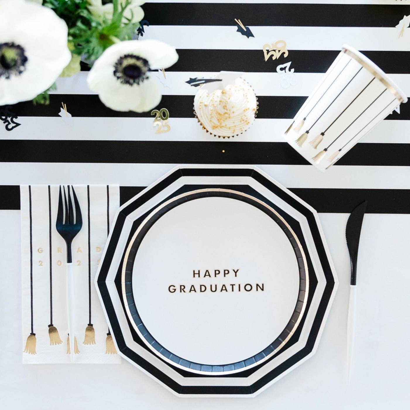 Graduation-themed table setting with 'Happy Graduation' plate, black and white 
