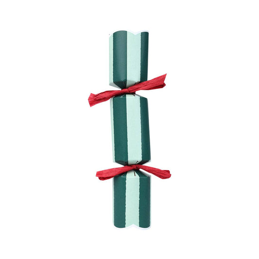 Two striped candles tied with a red ribbon on a white background