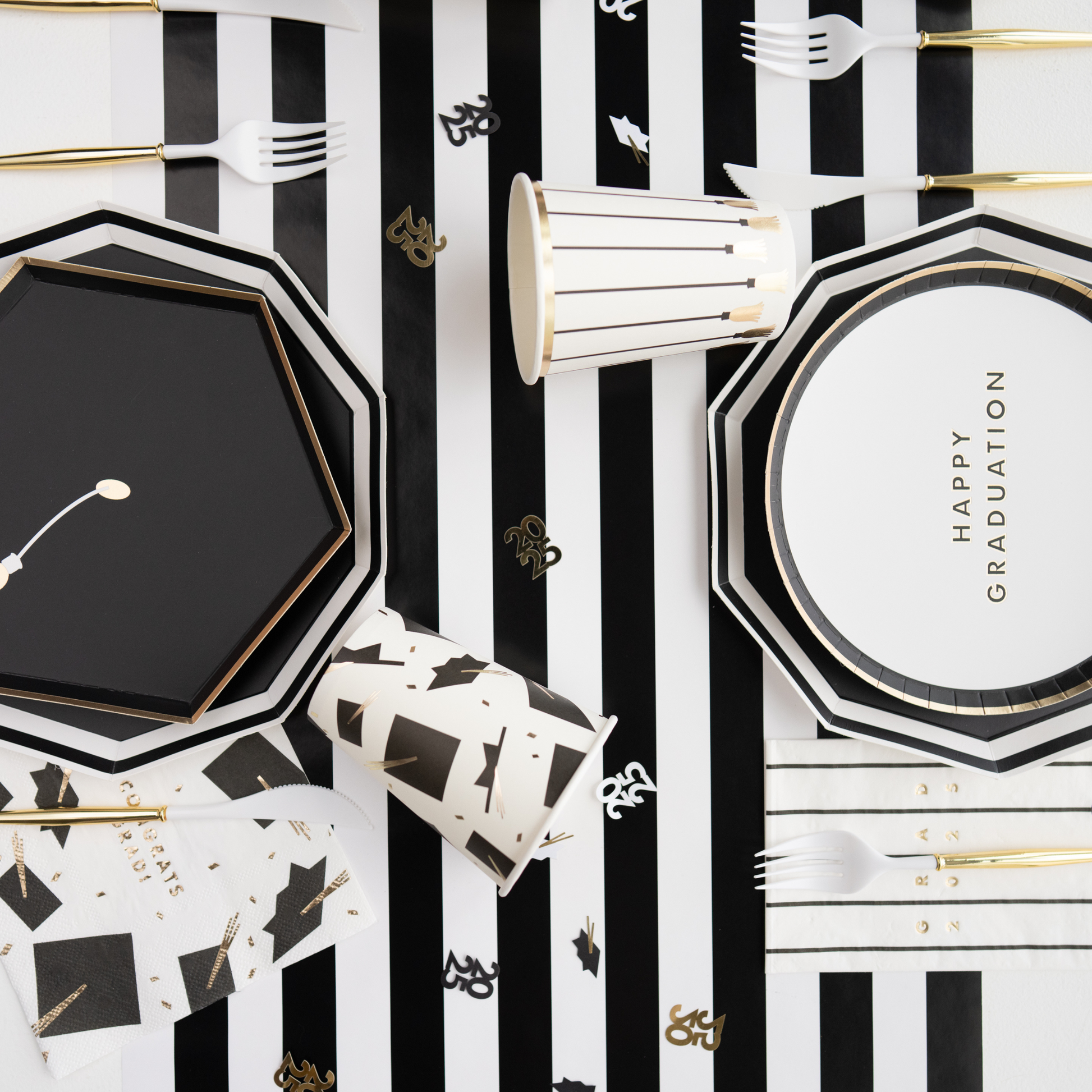 Graduation-themed party supplies with black, white, and gold design party supplies