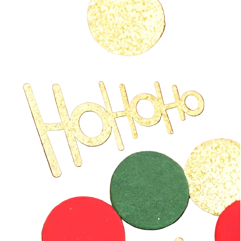 Gold glittery 'Ho Ho Ho' letter cutouts arranged on a white surface with red and green glitter and confetti circles around them. 