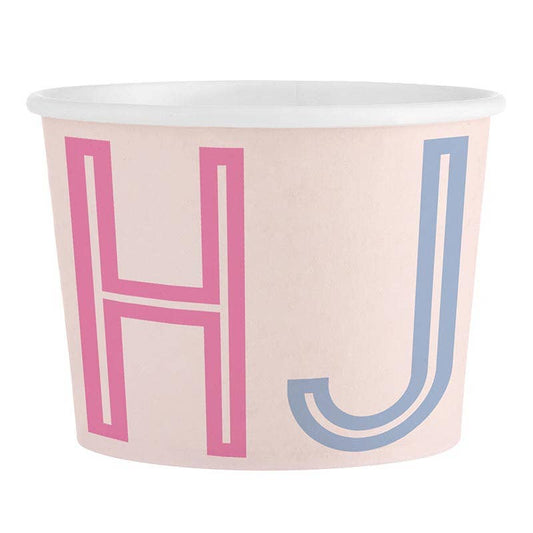 Paper cup with pink and blue letters 'MAHJ' on a light pink background