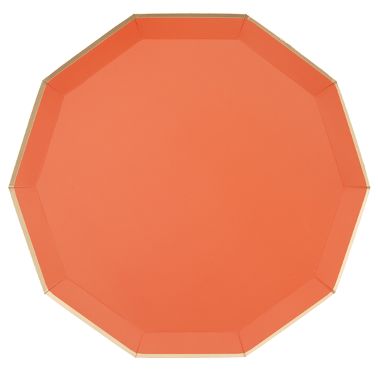 Orange paper plate with gold rim on a white background