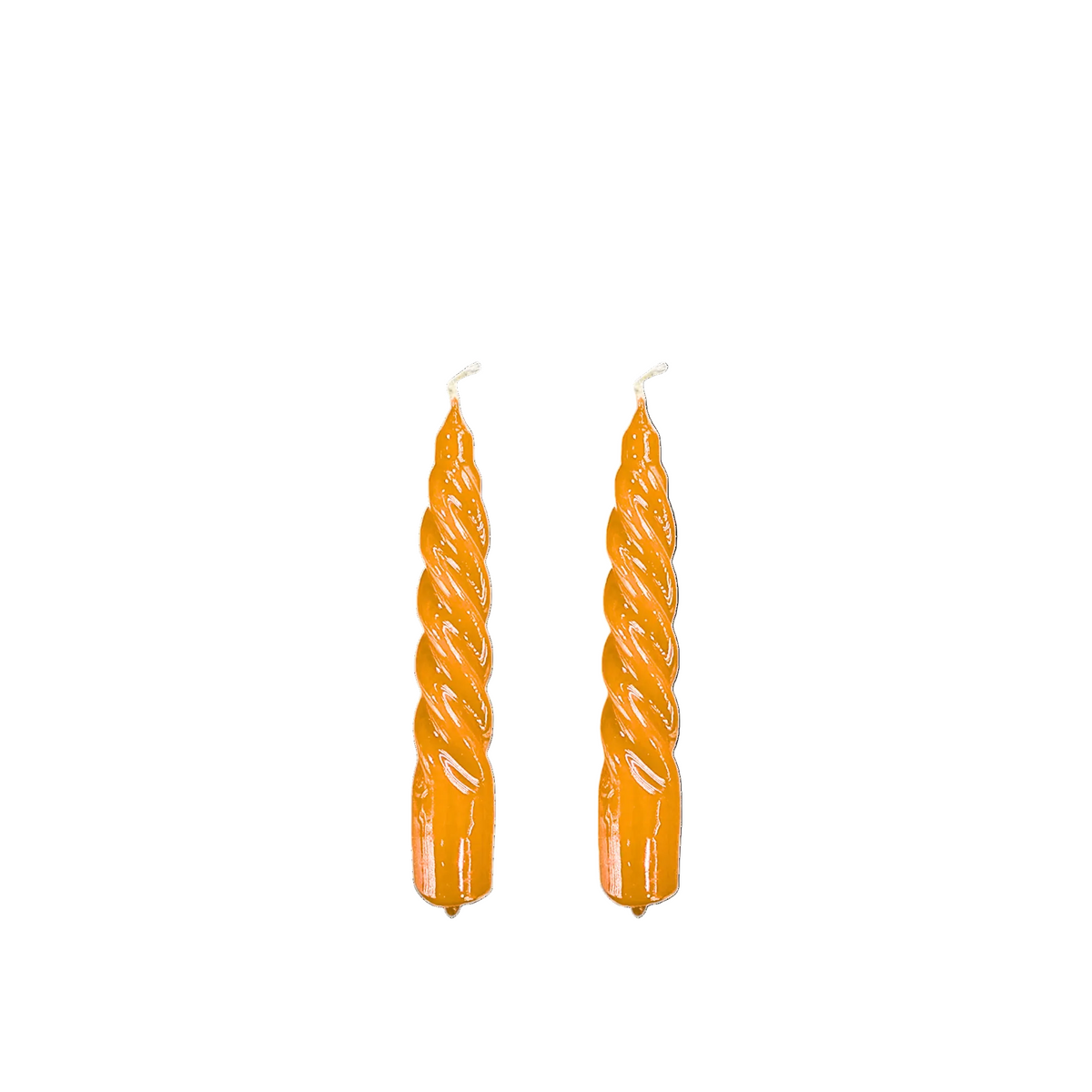Two orange spiral taper candles with white wicks, shown vertically against a plain white background.