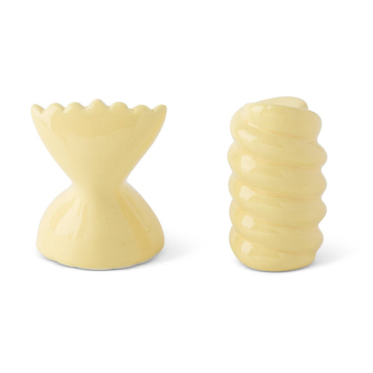 Two beige pasta-shaped salt and pepper shakers on a white background