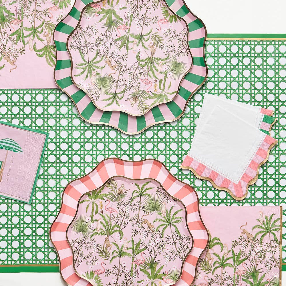 Set of decorative plates with floral patterns on a green and pink checkered tablecloth.