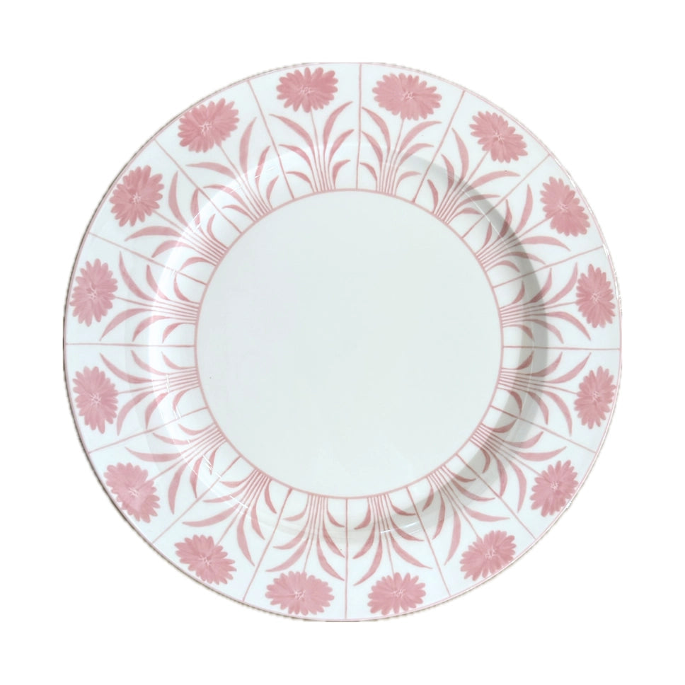 A round white ceramic plate featuring a delicate pink floral pattern printed along its rim, shown against a plain white background.