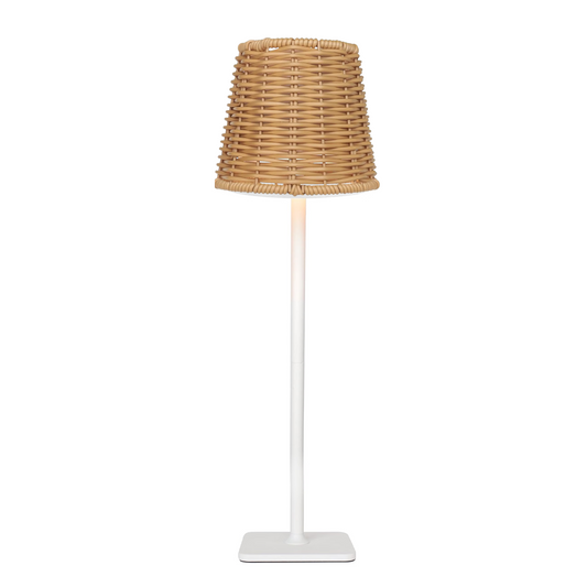 A rechargeable table lamp featuring a tapered woven rattan shade in a natural tan color, supported by a slim white pole and a square white base, set against a plain white background