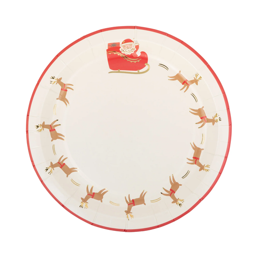 A round paper party plate with a Christmas theme, featuring a red rim, a Santa Claus in a sleigh at the top, and a circle of brown reindeer with red harnesses around the edge on a white background.