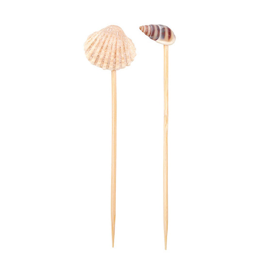 Two shell-shaped toothpicks on wooden sticks against a white background