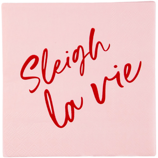 Pink cocktail napkin with red text 'Sleigh la vie' on a white background