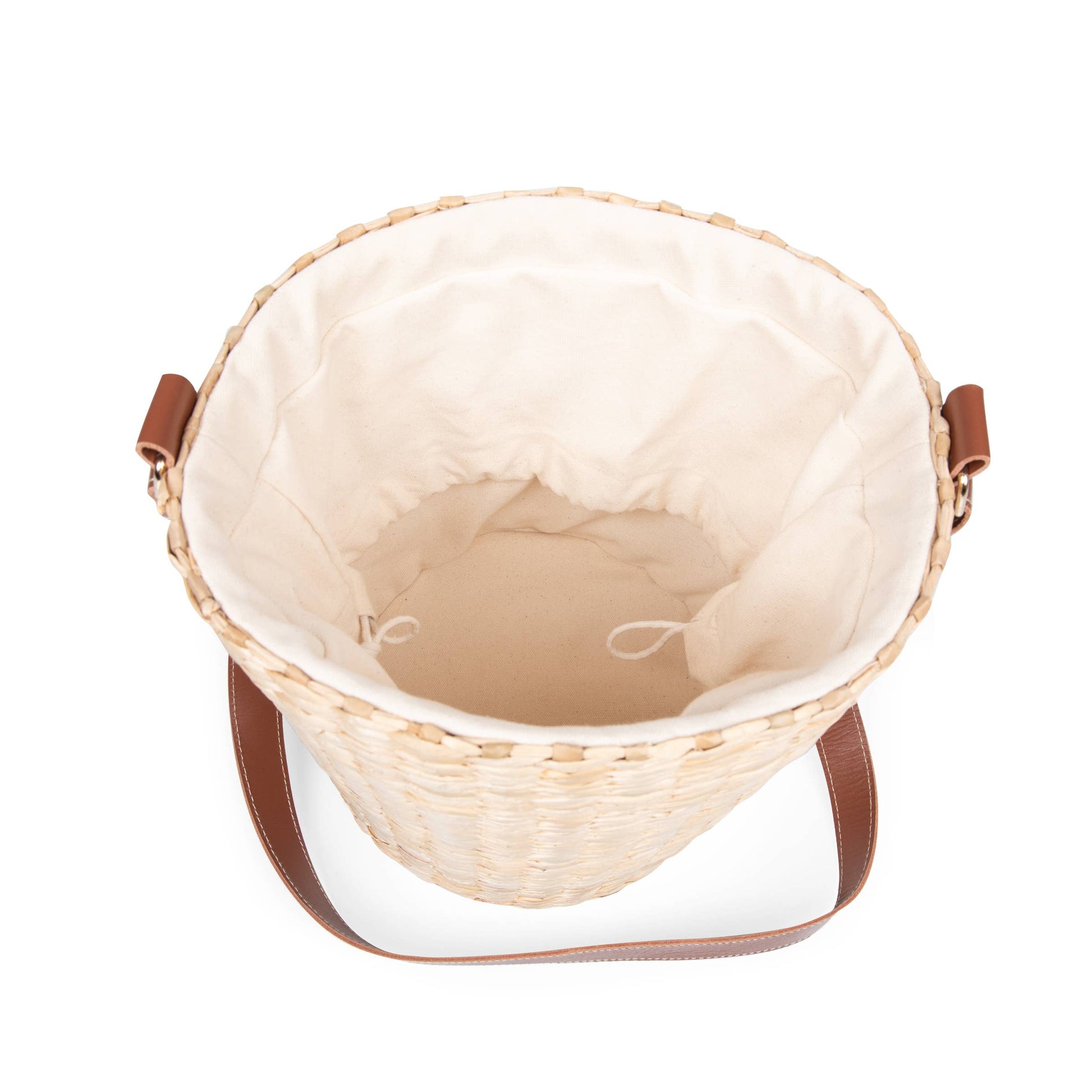 Top-down view of a woven straw bucket bag with a cream fabric lining and brown shoulder straps, shown on a white background.