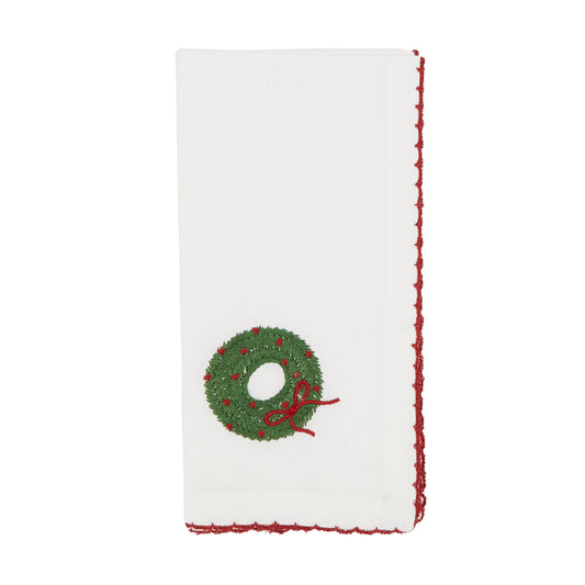 White napkin with a green wreath design on a white background